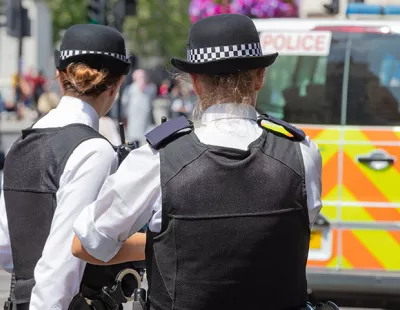 Two female police officers by a police van