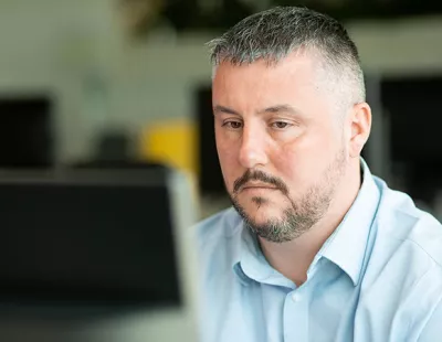 Bearded white man at a computer