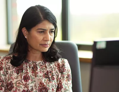 British Asian woman sitting at computer