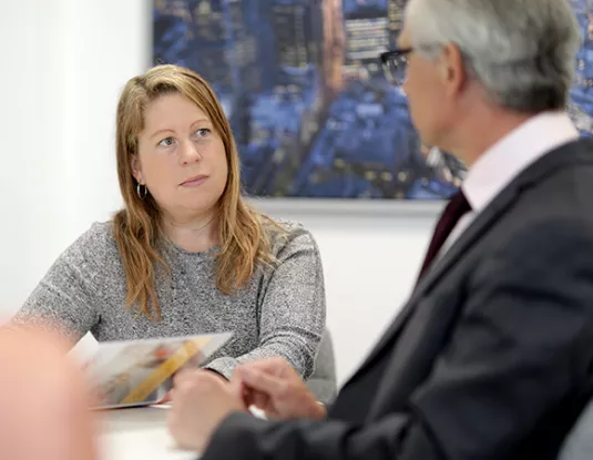 Woman talking to male colleague in an office
