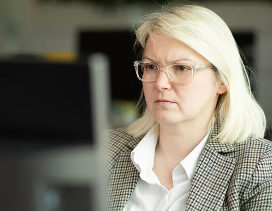 Blonde woman with glasses in an office