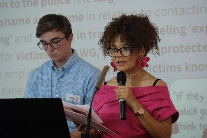 A female and male Youth Panel members speak at the showcase event 2025