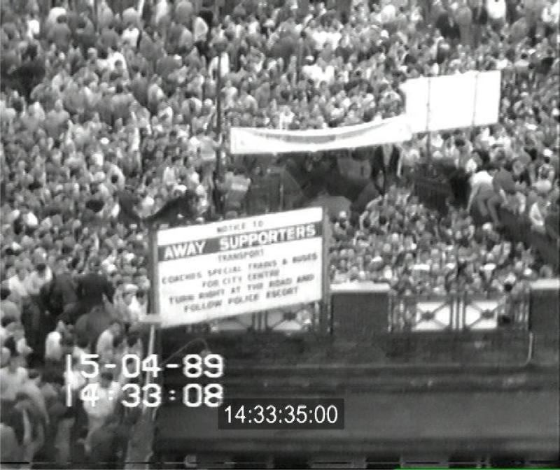 CCTV still of the crowd build-up outside the Leppings Lane entrance at Hillsborough Stadium, 14:33:35