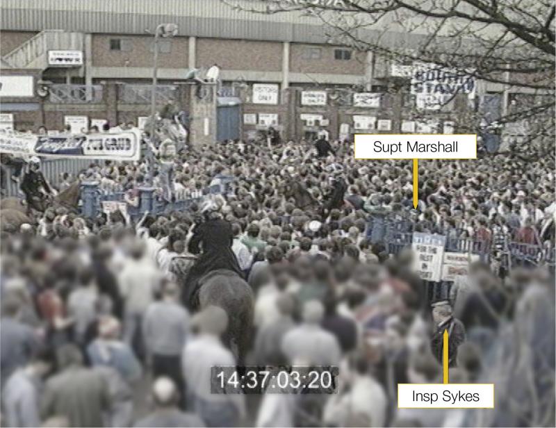 The crowd outside the Leppings Lane turnstiles at Hillsborough Stadium at 14:37:03