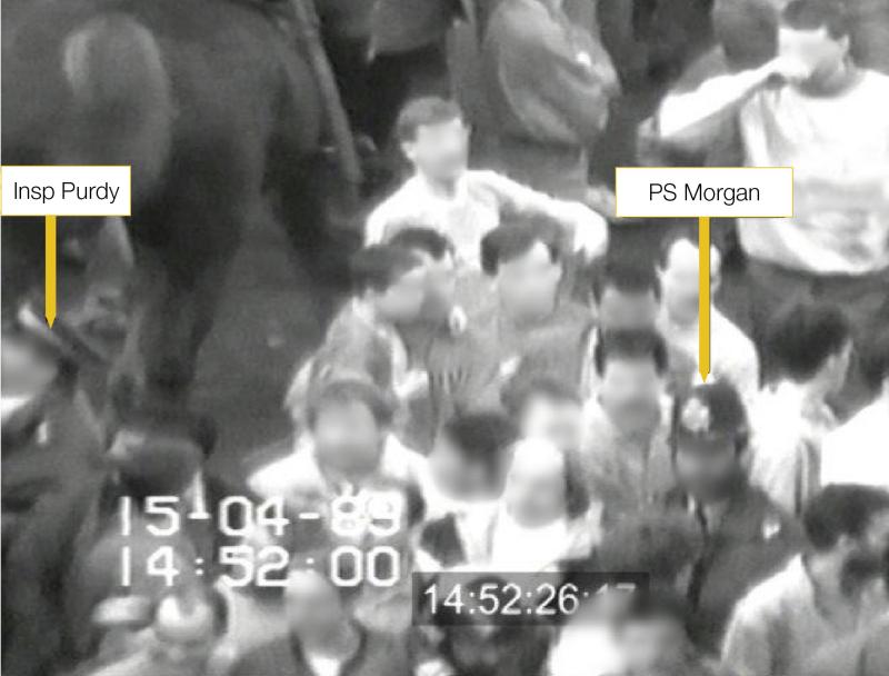 PS Morgan leading supporters on the service road by Hillsborough Stadium at 14:52:26